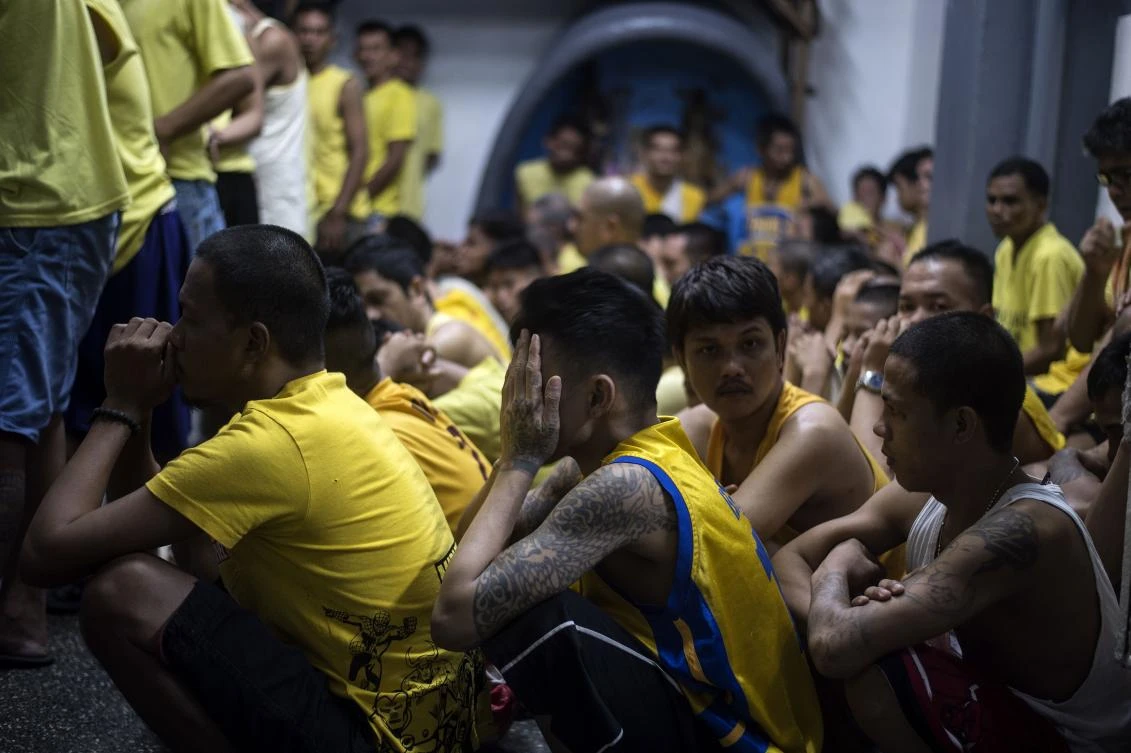 This photo taken on July 27, 2017 shows inmates during a morning head count inside the Quezon City Jail in Manila. A notoriously slow and under-resourced judicial system has seen a "tidal wave" of new cases as police have conducted a nationwide crime crackdown in response to President Rodrigo Duterte's order to eradicate all illegal drugs from Philippine society. (AFP)
