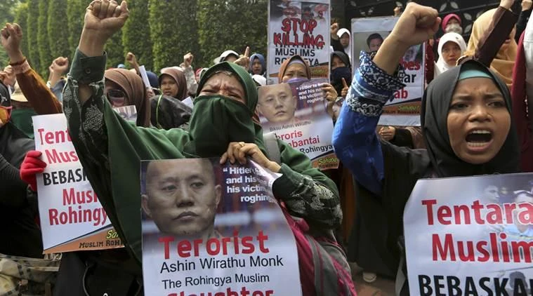 Muslim women raise their fists as they shout slogans during a rally against persecution of Rohingya Muslim minority, outside Myanmar Embassy in Jakarta, Indonesia. (AP)