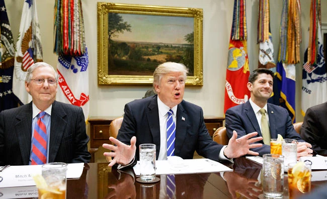 President Donald Trump, flanked by Senate Majority Leader Mitch McConnell of Ky., left, and House Speaker Paul Ryan of Wis., speaks in the Roosevelt Room of the White House in Washington. (AP)