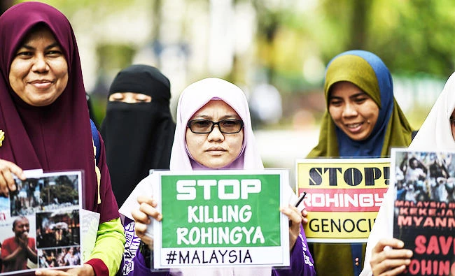 Women hold up placards during a protest against the persecution of Muslim ethnic minority Rohingya in Myanmar, in Kuala Lumpur, in this August 30, 2017 photo. (AFP)