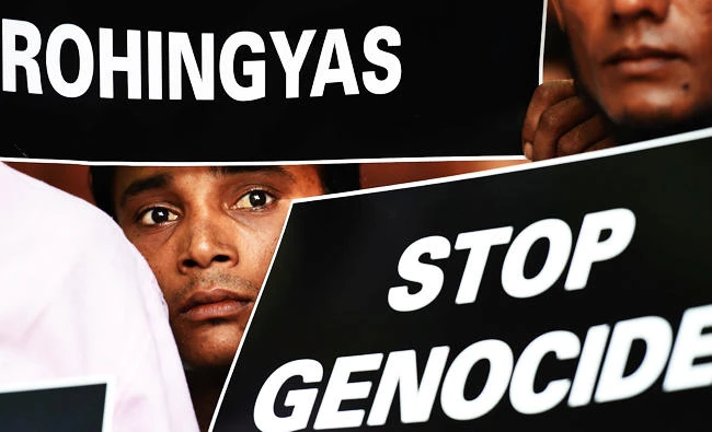 Rohingya Muslim refugees hold placards against human rights violations in Myanmar during a protest in New Delhi on Tuesday. (AFP)