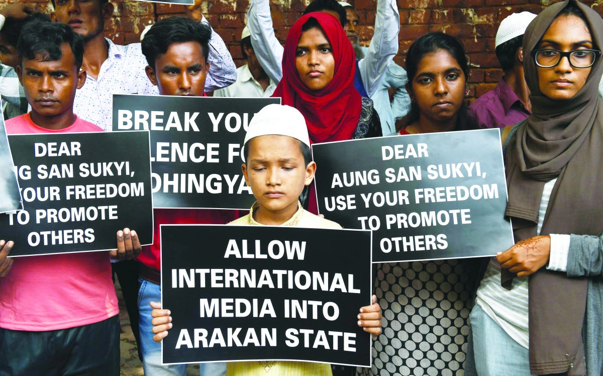Rohingya Muslim refugees along with Indian supporters hold placards against human rights violationsin Myanmar during a protest in New Delhi on Tuesday. (AFP)