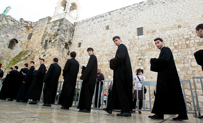 Members of the Armenian clergy parade at Manger Square outside the Church of the Nativity during the Armenian Christmas celebrations in the biblical West Bank town of Bethlehem, in this January 18, 2015 file photo. (AFP)