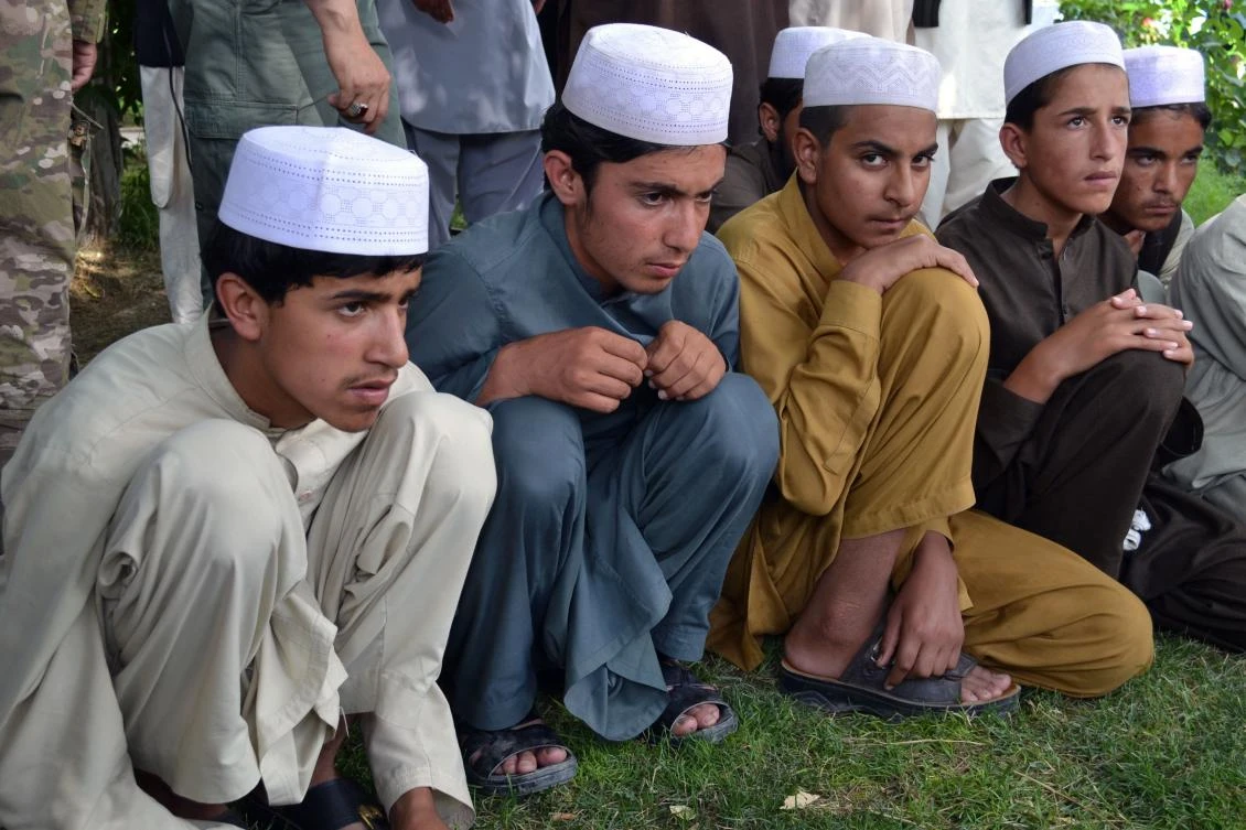 In this photograph taken on July 15, 2017, Afghan children released from captivity are presented to the media at the police headquarters in Ghazni. The rescue this summer of dozens of Afghan youths destined for Pakistan religious schools to be trained as Taliban fighters has bolstered claims that insurgents are increasingly recruiting children to reinforce their ranks. (AFP)