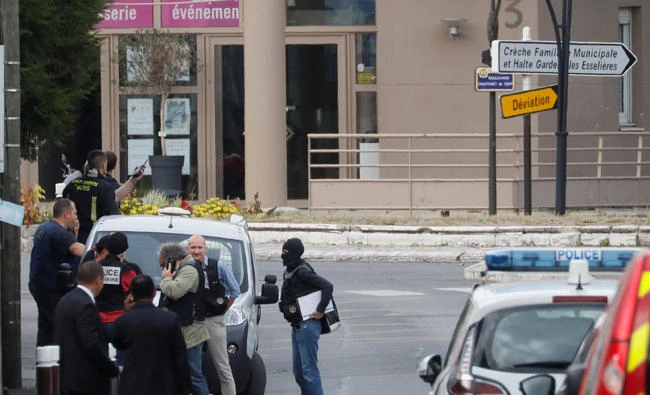 French investigators and firefighters are seen during a police operation after components that can be used to make explosives were found in a flat in Villejuif, near Paris, on Wednesday. (REUTERS/Gonzalo Fuentes)