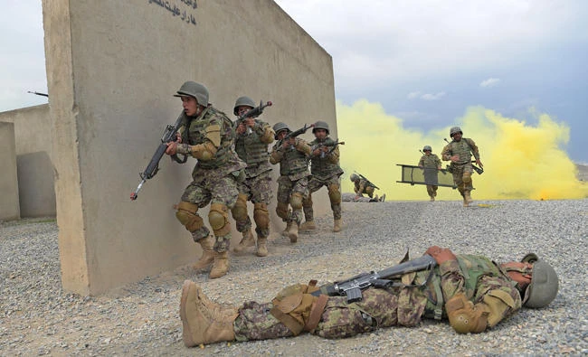 In this photograph taken on May 3, 2017, Afghan National Army (ANA) soldiers train at the Kabul Military training center (KMTC) in a program overseen by US-led international forces. A US official apologized on Wednesday for leaflets dropped in Afghanistan that were deemed offensive to Islam. (AFP / SHAH MARAI)