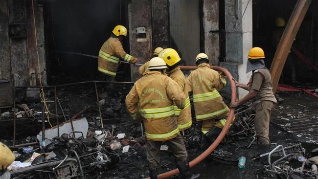 This file image shows Indian firefighters containing a fire at a factory in Sivakasi in the southern India state of Tamil Nadu on October 20, 2016. (AFP)
