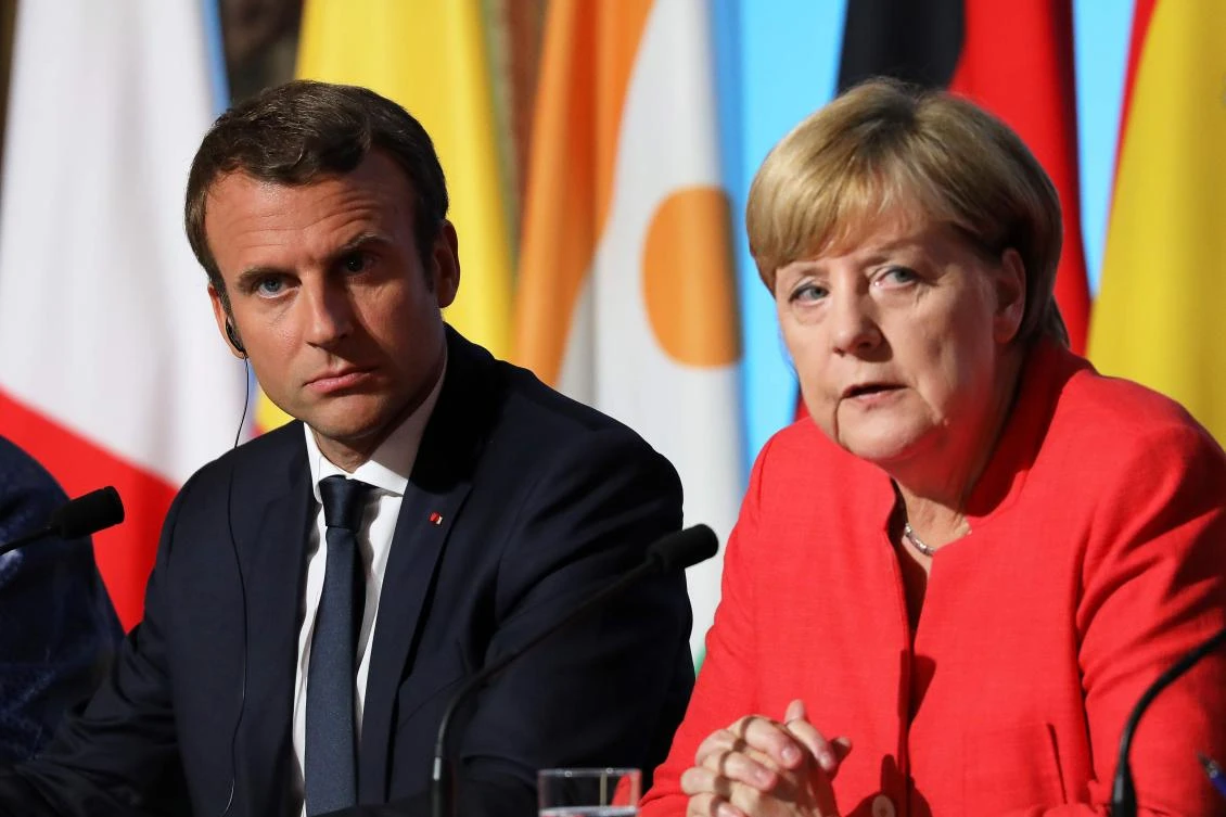 French President Emmanuel Macron (L) and German Chancellor Angela Merkel attend a meeting with EU and African leaders to discuss how to ease the European Union's migrant crisis, at the Elysee Palace in Paris, on August 28, 2017. Seven African and European leaders met in Paris on August 28 to try to build a "new relationship" aimed at stemming the flow of migrants into Europe from northern Africa in return for aid. (AFP)