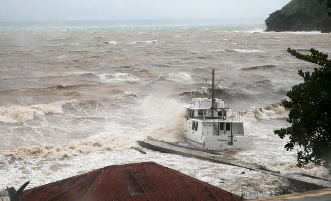 Waves crash against a boat near the shore as Hurricane Irma passes over Samana, Dominican Republic on Thursday. Hurricane Irma cut a path of devastation across the northern Caribbean. (AP)