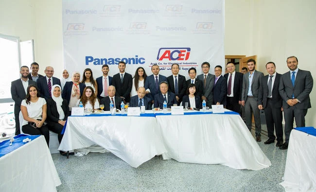Officials from Panasonic and the Arab Co. for Electrical Equipment pose for a photo during an event.