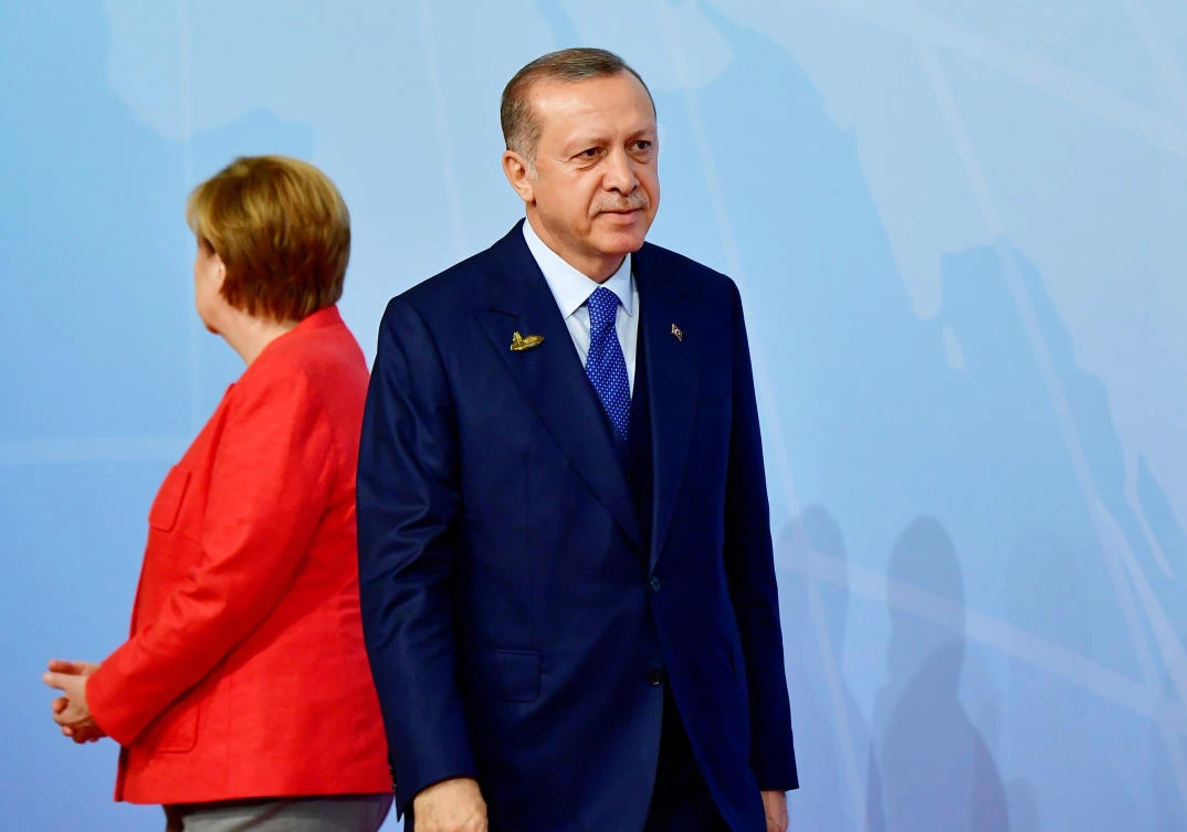 File photo shows German Chancellor Angela Merkel, left, standing next to Turkey's President Recep Tayyip Erdogan at the G-20 summit in Hamburg. (AFP)