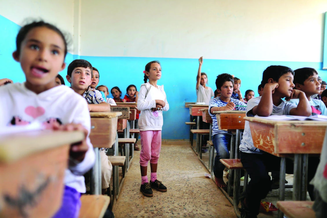 Children attend their class after getting registered at the school in Hazima Raqqa, Syria. (Reuters)