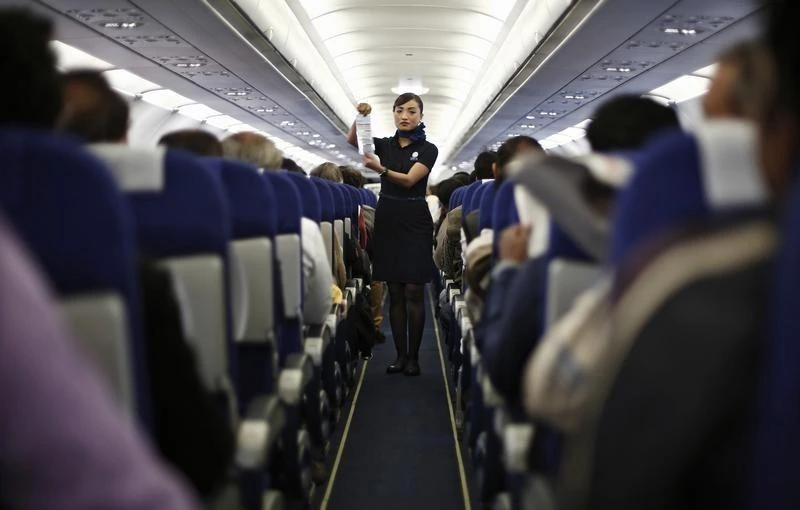 Above, an Indigo Airlines cabin crew goes over safety guidelines during a flight. (Reuters)