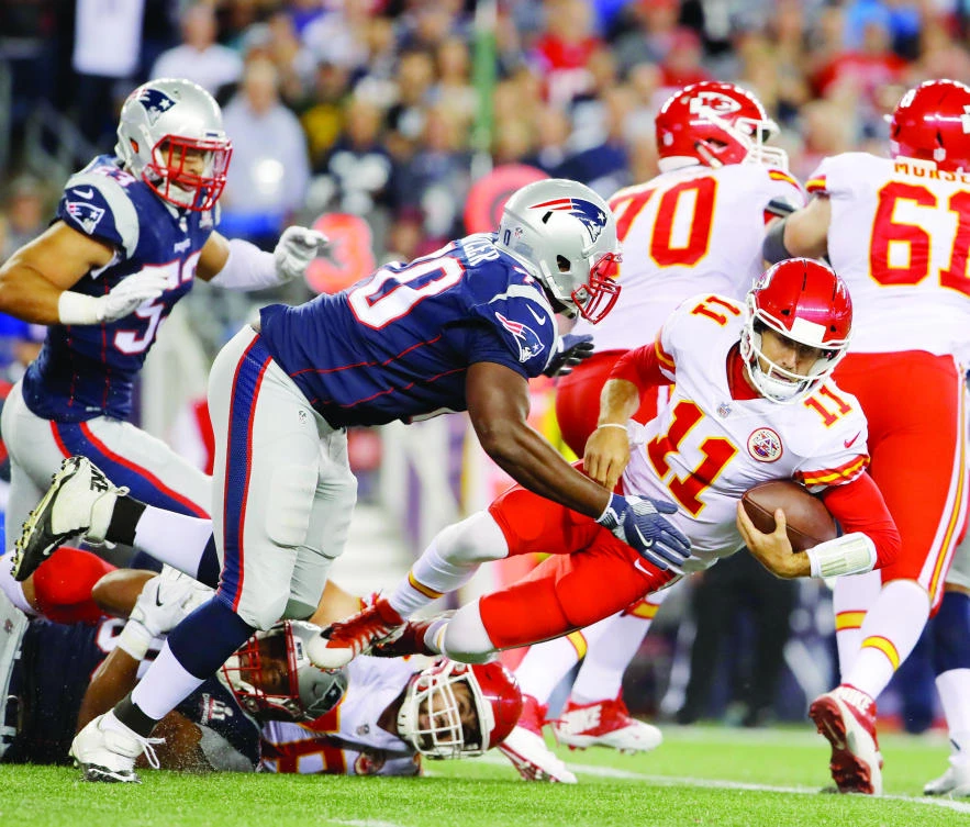 Kansas City Chiefs quarterback Alex Smith (11) is tackled by New England Patriots defensive tackle Adam Butler (70) during the fourth quarter at Gillette Stadium in Foxborough, Massachusetts. (USA TODAY Sports)