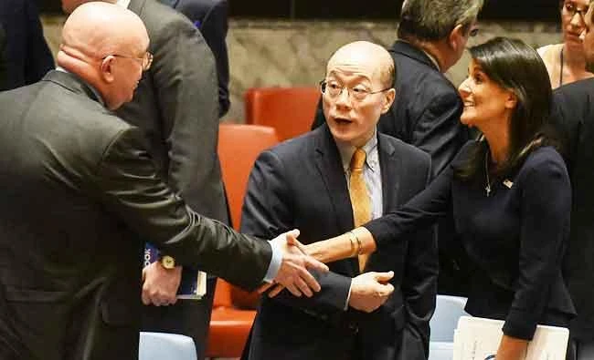 Ambassador to the UN, Nikki Haley, speaks on the sidelines with Chinese Ambassador Liu Jieyi while she shakes hands with Russian Ambassador Vasilly Nebenzia after a United Nations Security Council meeting on North Korea, in this September 4, 2017 photo, in New York City. (AFP)