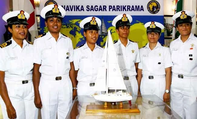 This handout photo taken on August 17, 2017 and released on September 5 by the Indian Navy shows Indian women naval officers posing for a picture in front of a model of a yacht in New Delhi, promoting their upcoming effort to sail around the world. (AFP)