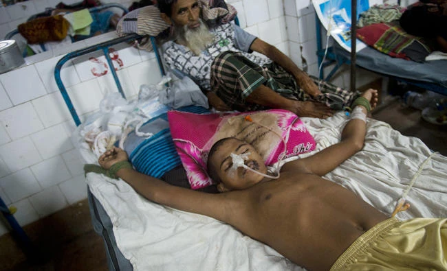 16-year-old Rohingya refugee Mohammad Junaed is tied to a bed to stop him jumping out of it in the Chittagong Medical College hospital on September 7, 2017. The hospital is the only facility in the area with the facilities to treat serious gunshot wounds and has been utterly overwhelmed since fresh violence broke out in Myanmar's Rakhine state two weeks ago, triggering a flood of mostly Rohingya refugees across the border. (AFP)