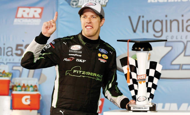 Brad Keselowski, driver of the #22 Fitzgerald Glider Kits Ford, celebrates in victory lane after winning the NASCAR XFINITY Series Virginia529 College Savings 250 at Richmond International Raceway on Friday in Richmond, Virginia. (AFP)