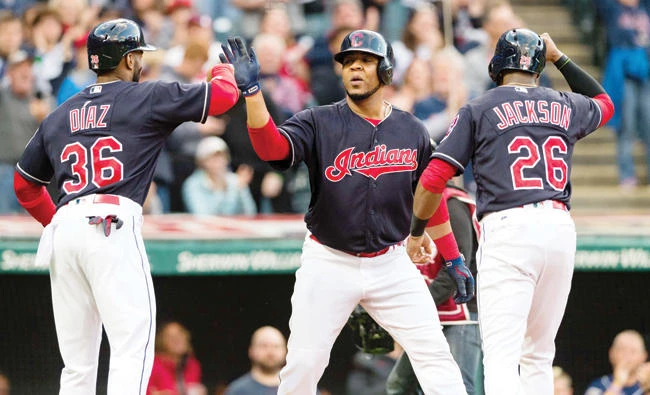 Yandy Diaz (36) and Austin Jackson (26) celebrate with Edwin Encarnacion of the Cleveland Indians after all scored on a home run by Encarnacion during the first inning against the Baltimore Orioles at Progressive Field on Friday in Cleveland, Ohio. (AFP)