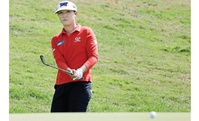 Lydia Ko, of New Zealand, chips to the eighth green during the Indy Women in Tech Championship golf tournament Friday in Indianapolis. (AP)