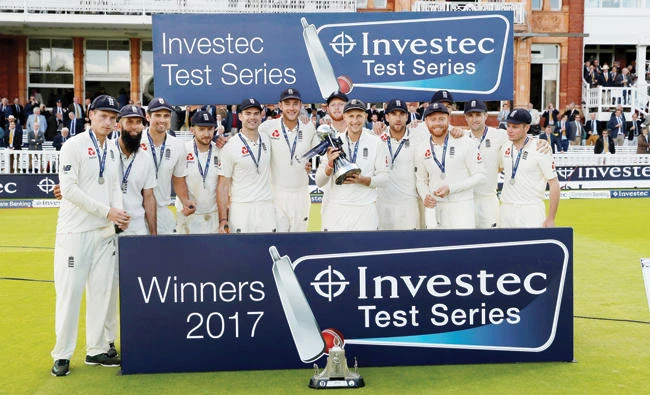 England’s Joe Root and teammates celebrate with the trophy after winning the Investec Test Series against West Indies on Saturday. (Reuters)