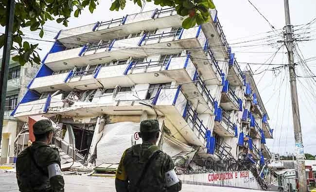 Soldiers stand guard a few metres away from the Sensacion hotel which collapsed with the powerful earthquake that struck Mexico overnight, in Matias Romero, Oaxaca State, on Friday. (AFP)