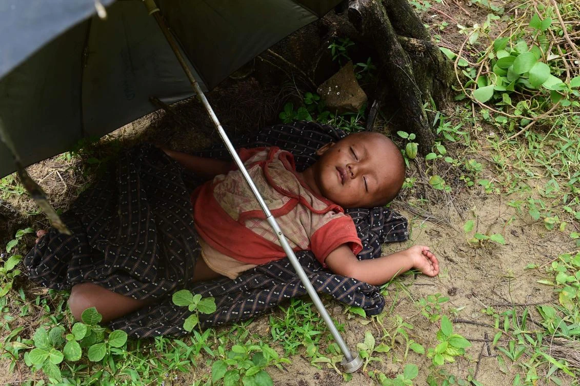 A Rohingya Muslim child sleeps after crossing the border from Myanamar, near the Bangladeshi town of Teknaf on September 10, 2017. Rohingya militants, whose August 25 raids in Myanmar's Rakhine State sparked an army crackdown that has seen nearly 300,000 of the Muslim minority flee to Bangladesh, on Sunday declared an immediate unilateral one-month ceasefire. Bedraggled and exhausted Rohingya refugees have arrived in huge numbers in Bangladesh's Cox's Bazar area for over two weeks, while tens of thousands more are believed to be on the move inside Rakhine, many in desperate conditions after more than a fortnight without shelter, food and water. (AFP)