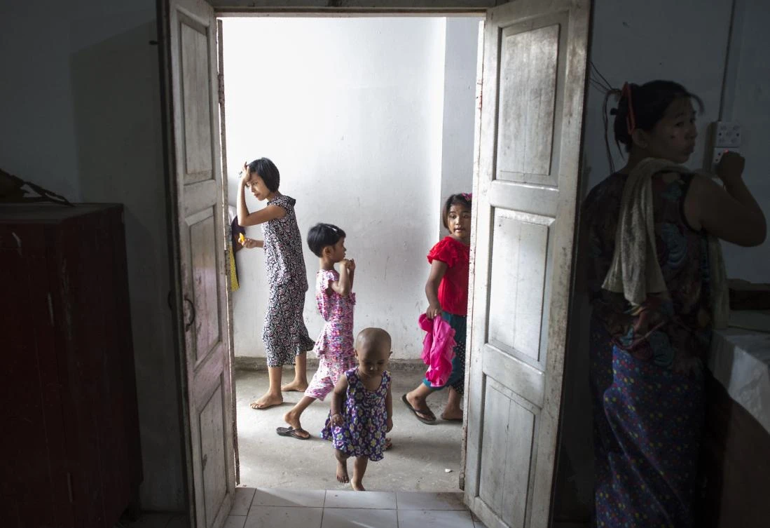 Ethnic Rakhine children, who escaped with their families from unrest in Myanmar's Rakhine state, walk inside a temporary shelter in Sittwe on August 30, 2017. At least 18,500 Rohingya have crossed into Bangladesh since fighting erupted in Myanmar's neighbouring Rakhine state six days ago, the International Organization for Migration said on August 30. Among the dead and displaced are also ethnic Rakhine Buddhists and other tribal groups, who say they are being targeted by Rohingya militants. (AFP)