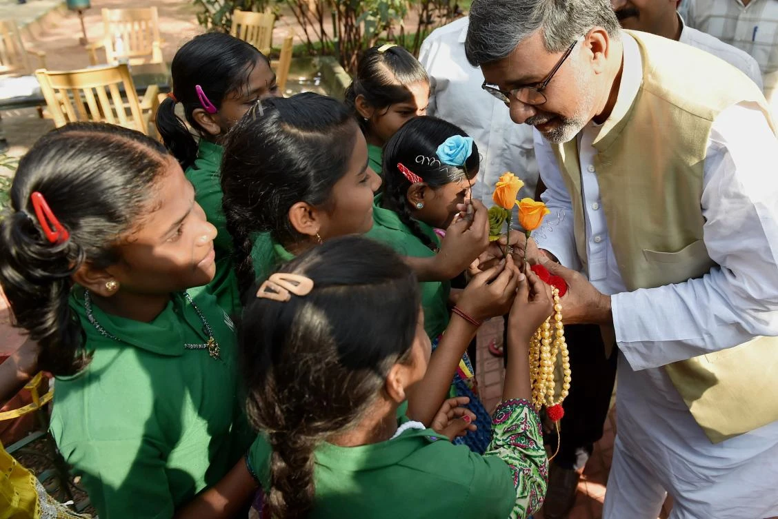 This file photo taken on November 6, 2015 shows Indian Nobel Peace Prize winner Kailash Satyarthi (R) receiving flowers from schoolchildren prior to a 'Meet the Press' event in Bangalore. Bruised and battered from previous campaigns against child labour, India's Nobel Peace Prize winner Kailash Satyarthi hopes one million people will join his latest drive starting on September 11, 2017 -- against the sexual abuse and trafficking of children. (AFP)