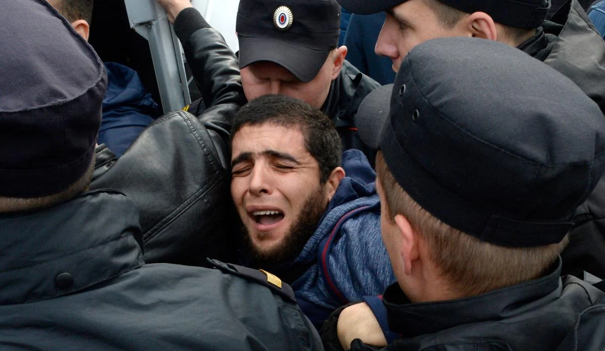Russian police officers detain a protester supporting the Rohingya Muslims, in Saint Petersburg on Sunday. (AFP)