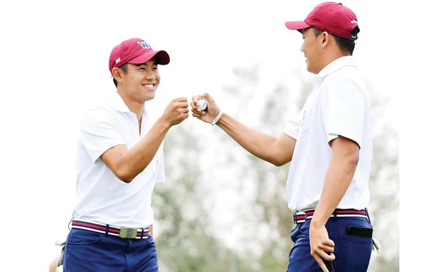 Collin Morikawa and Norman Xiong of Team USA celebrate a win of the third hole over Harry Ellis and Alfie Plant of Team Great Britain and Ireland during the foursomes in the 2017 Walker Cup at the Los Angeles Country Club on Saturday. (AFP)