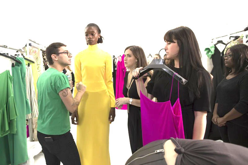 Designer Christian Siriano speaks to stylists and a model backstage ahead of the Christian Siriano Spring 2018 fashion show during New York Fashion Week, in New York. (AP)