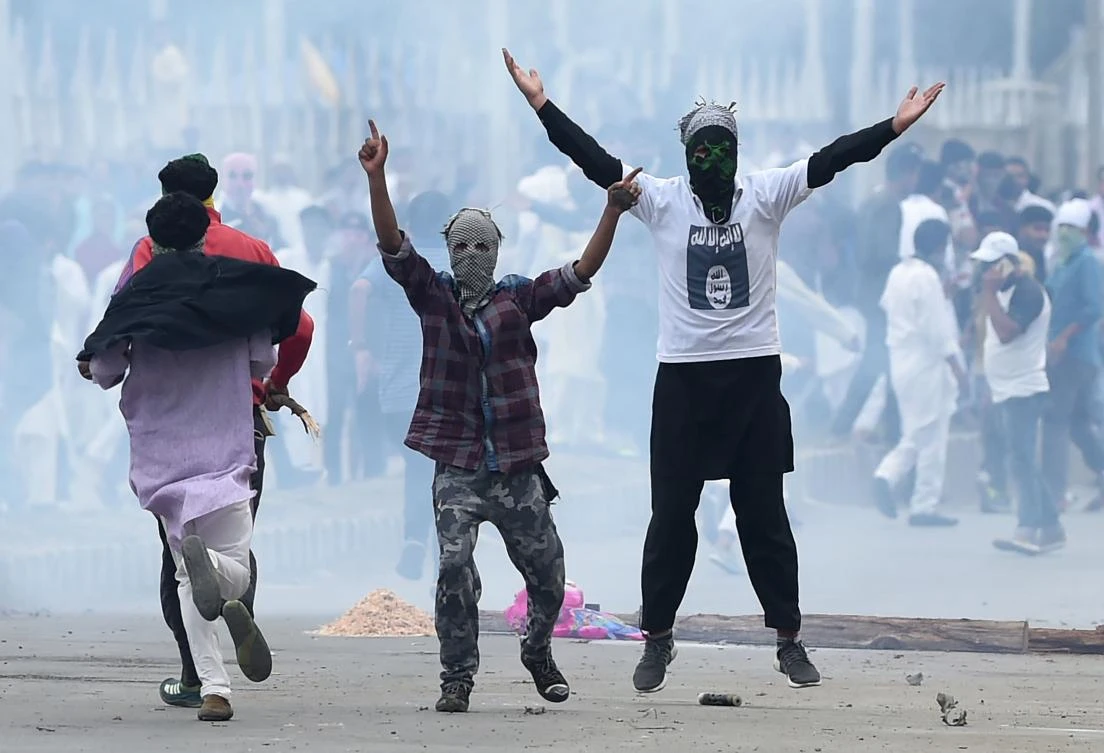 Kashmiri youths gesture during clashes between protestors and Indian government forces in Srinagar. (AFP)