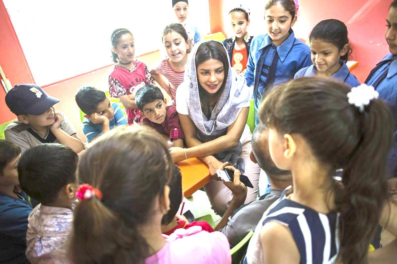 Priyanka Chopra, a UNICEF Goodwill Ambassador, greets a Syrian woman and her baby at UNICEF’s Makani Center in Amman, Jordan. (AP)