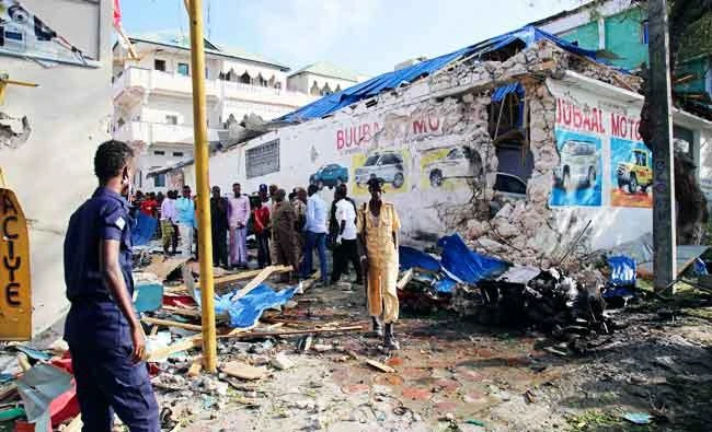 Somali soldiers walk at site of a car bomb attack in the centre of Mogadishu on Monday. (AFP)