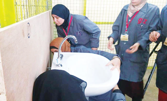 Trainee plumbers fix a sink in a program run by German Development Agency GIZ. (GIZ photo)