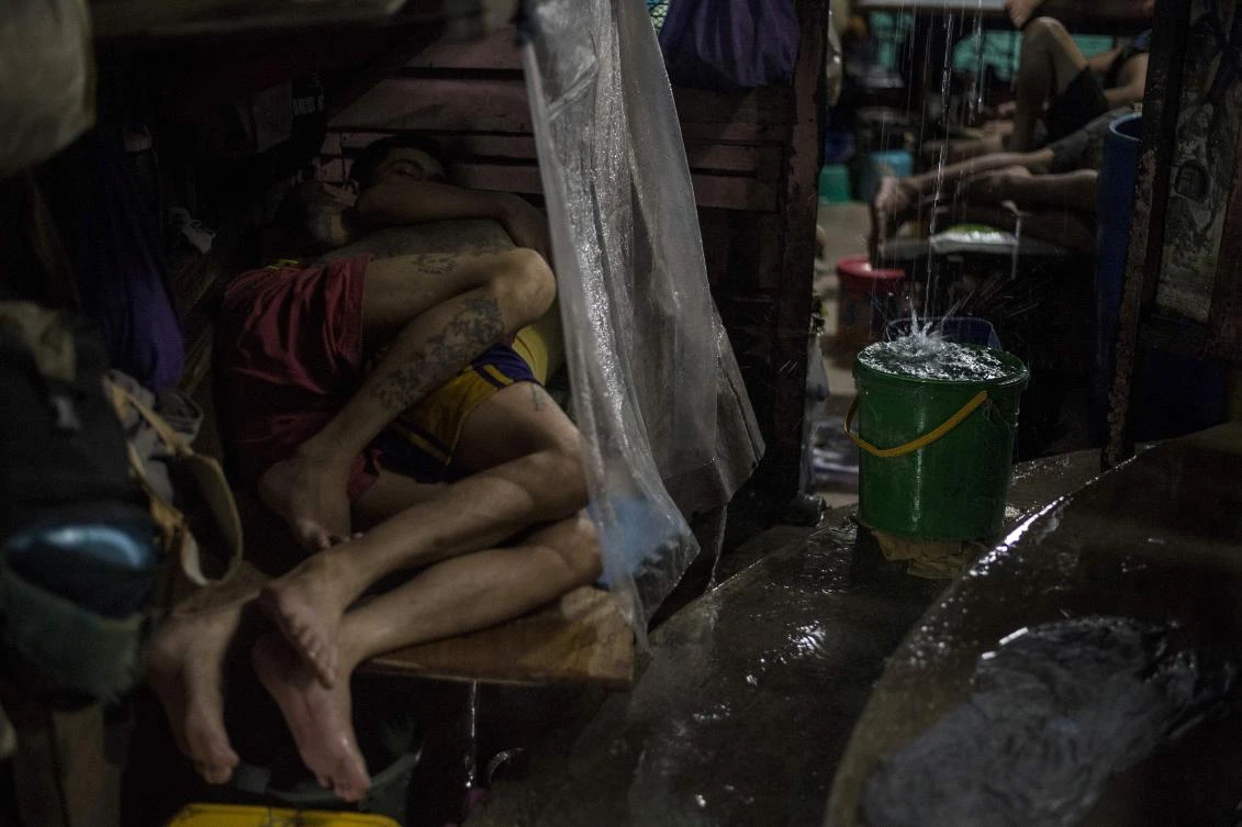 Inmates sleeping during a rainy night inside the Quezon City Jail in Manila.(AFP)