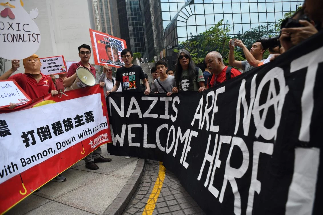 Veteran activist and former Hong Kong lawmaker Leung Kwok-hung (center R), and chairman of the League of Social Democrats (LSD) Avery Leung (center L), hold up banners with other activists during a protest against US President Donald Trump and the visit of former White House strategist Steve Bannon ahead of his expected speech for an investment firm in Hong Kong on September 12, 2017. (AFP)