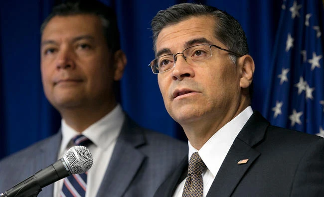California Attorney General Xavier Becerra, right, flanked by Secretary of State Alex Padilla, speaks to reporters in Sacramento. (AP)
