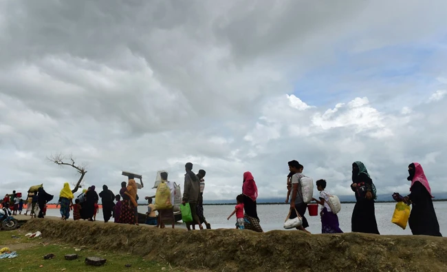 Rohingya Muslim refugees arrive from Myanmar after crossing the Naf river in the Bangladeshi town of Teknaf on Tuesday. (AFP)