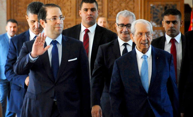 Tunisian Prime Minister Youssef Chahed arrives in Parliament on Monday with Speaker Mohamed Ennaceur before of a vote of confidence in his reshuffled government in Tunis. (AP)