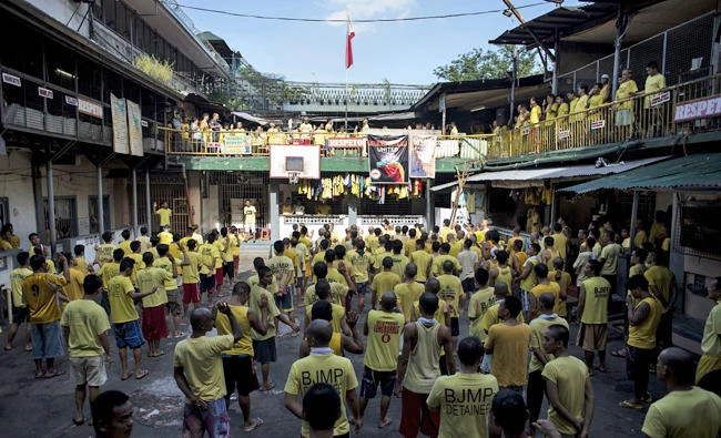 This photo taken on July 11, 2017 shows inmates attending a flag raising ceremony inside the Quezon City Jail in Manila. A notoriously slow and under-resourced judicial system has seen a "tidal wave" of new cases as police have conducted a nationwide crime crackdown in response to President Rodrigo Duterte's order to eradicate all illegal drugs from Philippine society. (AFP file photo)