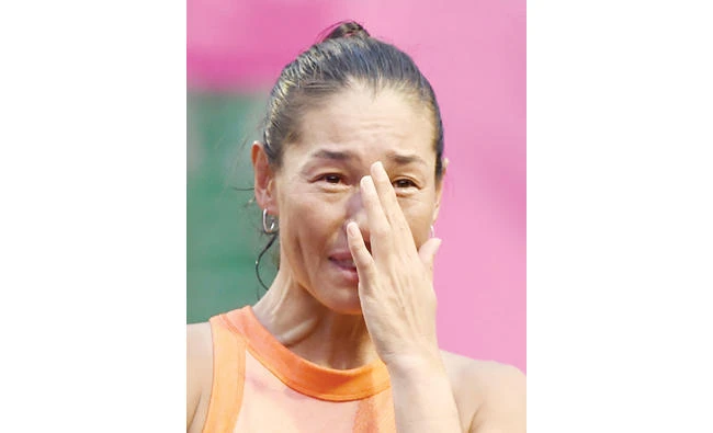 Japan’s Kimiko Date wipes her tears during a ceremony after her last match of her career against Serbian Aleksandra Krunic in the first round of the Japan Wemen’s Open tennis tournament in Tokyo on Tuesday. (AFP)