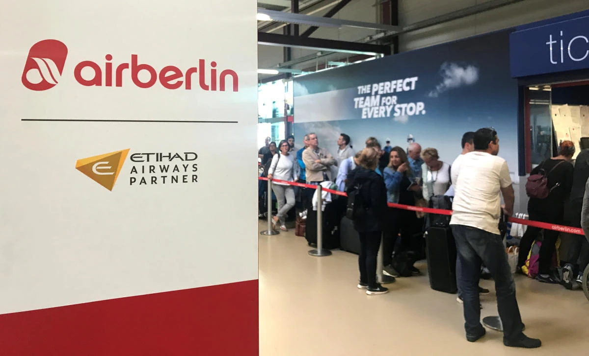 People wait at the Tegel airport service point. Air Berlin said 200 of its 1,500 pilots had suddenly called in sick, forcing the scrapping of around 100 flights. (Reuters)