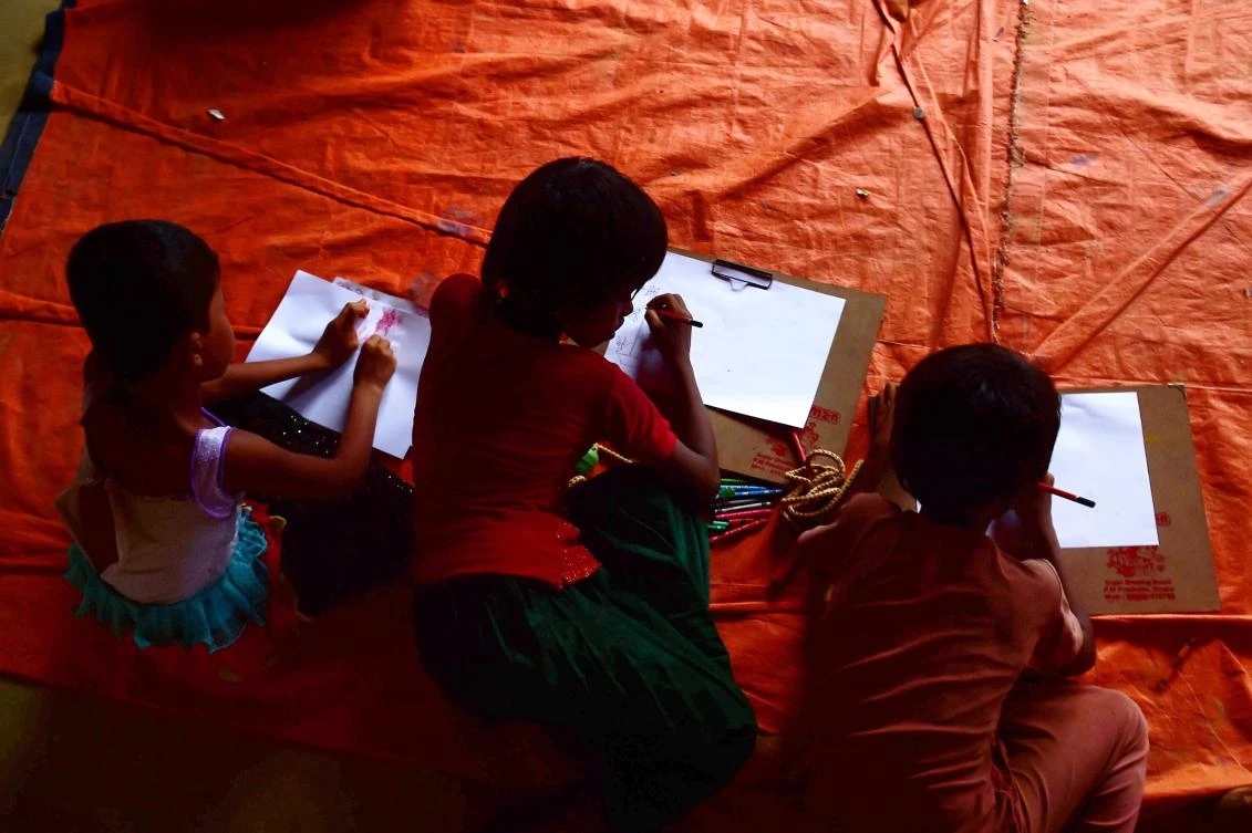 Rohingya Muslim refugee children draw pictures at a safe house in Kutupalong refugee camp in the Bangladeshi town of Teknaf. (AFP)