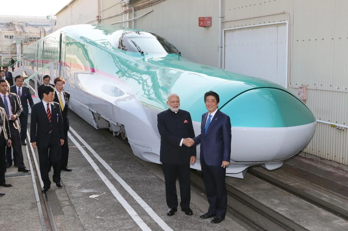 India's Prime Minister Narendra Modi (2nd R) and his Japanese counterpart Shinzo Abe (R) shake hands. (AFP)