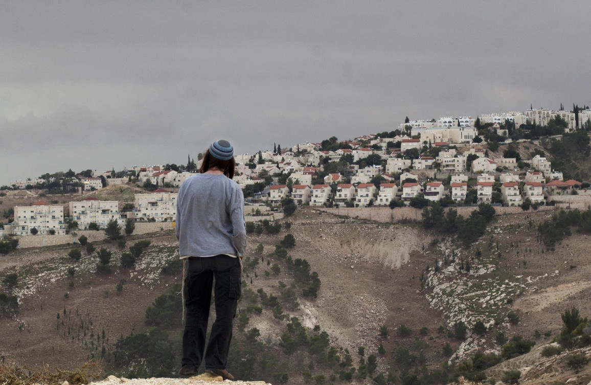 A Jewish settler looks at the West bank settlement of Maaleh Adumim. (AP)