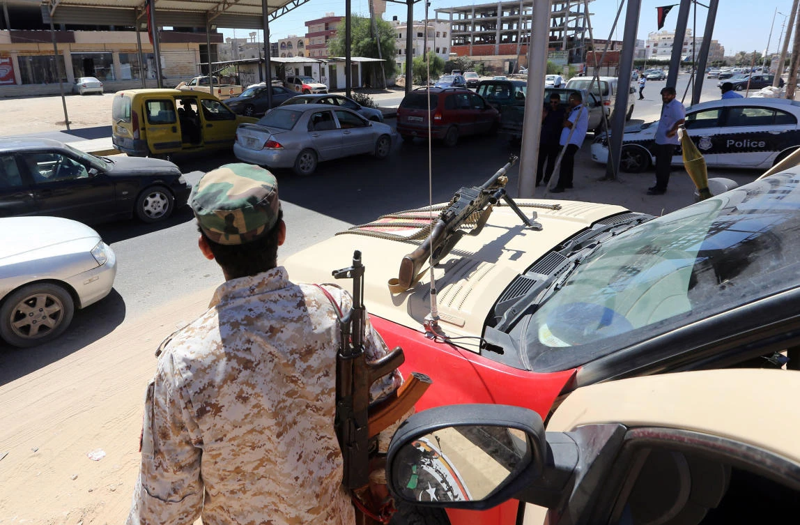Members of a Libyan force tackling clandestine migration man a checkpoint in Sabrata, about 70 kms (43 mi) west of the Libyan capital Tripoli, on September 11, 2017. In Sabrata, Libya's main departure point for clandestine migrants hoping to reach Europe, people trafficking gangs are under so much pressure that some have closed for business, local officials say. (AFP)