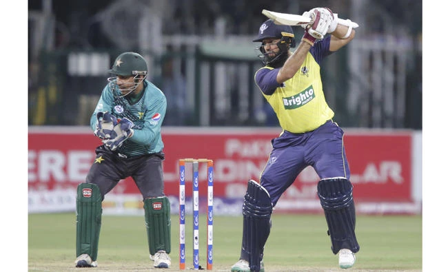 World XI batsman Hashim Amla plays a shot as Pakistan's Sarfraz Ahmed looks on during the second Twenty20 match at the Gaddafi Cricket Stadium in Lahore Wednesday. (AP)