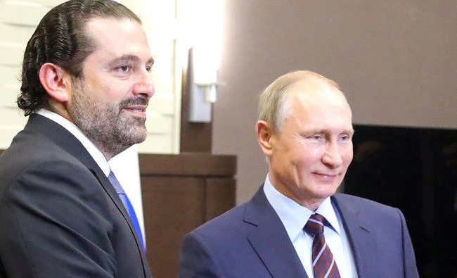 Russian President Vladimir Putin, right, shakes hands with Lebanese Prime Minister Saad Hariri during a meeting in Sochi on Wednesday. (AFP)